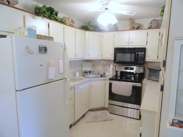 kitchen with white cabinetry, sink, a textured ceiling, white appliances, and light tile patterned floors