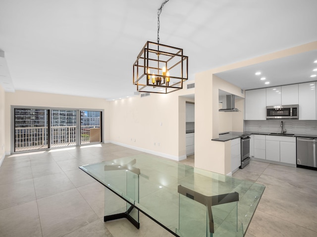 unfurnished dining area featuring sink and a chandelier