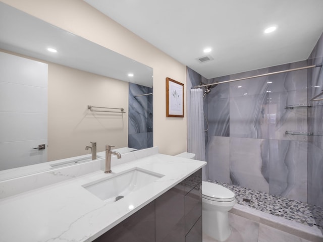 bathroom featuring vanity, toilet, and curtained shower