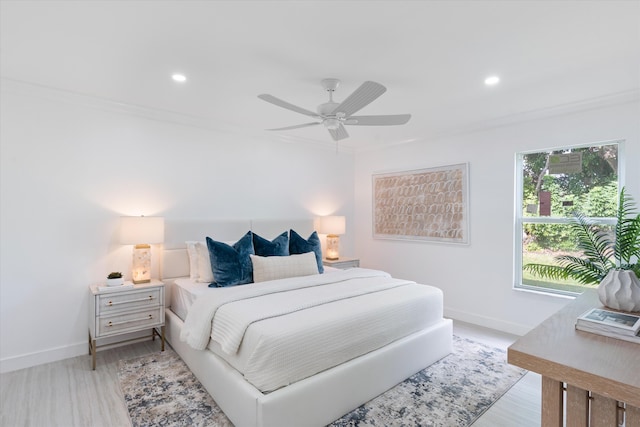 bedroom with ceiling fan, light wood-type flooring, and ornamental molding