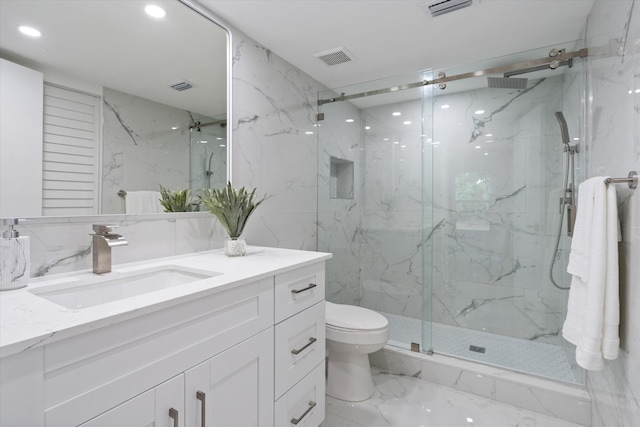 bathroom featuring vanity, toilet, and a shower with door