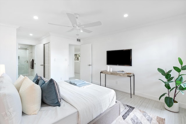 bedroom featuring ceiling fan, crown molding, ensuite bathroom, and light wood-type flooring