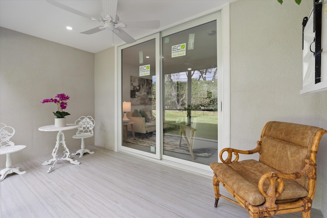 interior space with ceiling fan