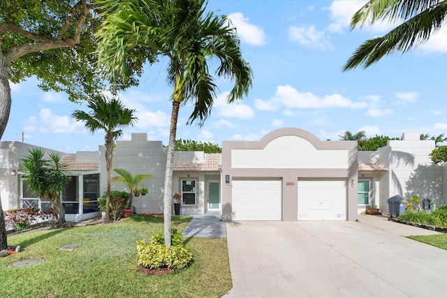 view of front of property with a garage and a front yard