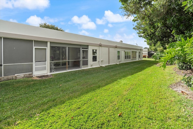 back of property featuring a yard