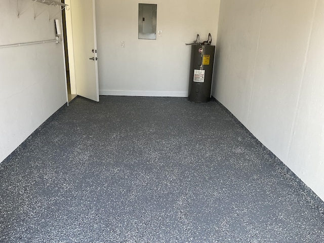 garage featuring electric panel and electric water heater