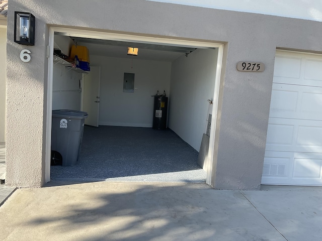 garage featuring electric panel and water heater