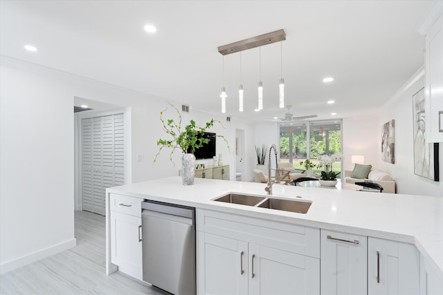 kitchen featuring stainless steel dishwasher, pendant lighting, white cabinetry, and sink