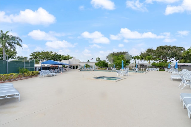 view of pool featuring a community hot tub and a patio area