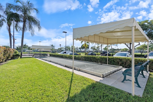 view of parking / parking lot with a lawn