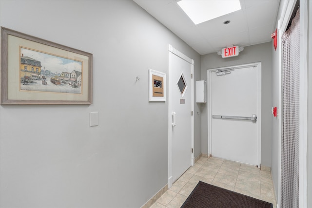 corridor featuring light tile patterned floors