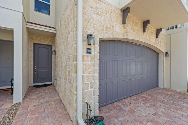 view of exterior entry featuring a garage