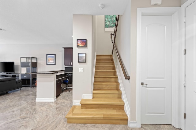 staircase with hardwood / wood-style flooring