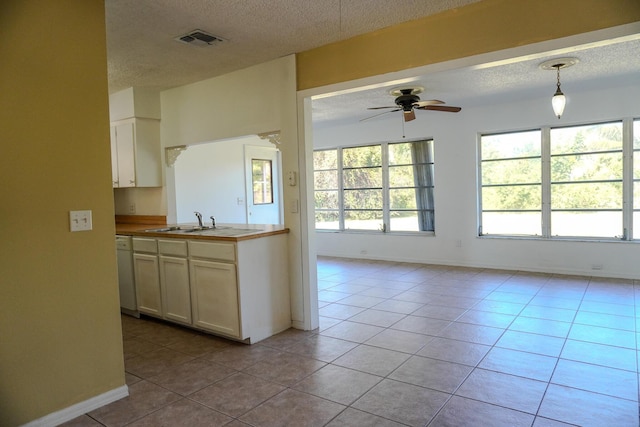 kitchen featuring pendant lighting, plenty of natural light, and light tile patterned floors