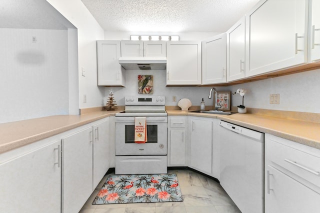 kitchen with white cabinetry, sink, a textured ceiling, and white appliances