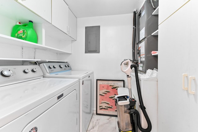 clothes washing area featuring cabinets, separate washer and dryer, and electric panel