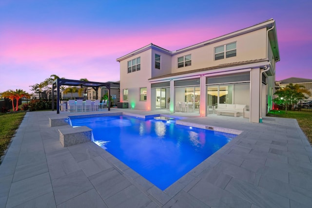 pool at dusk with a pergola, outdoor lounge area, and a patio