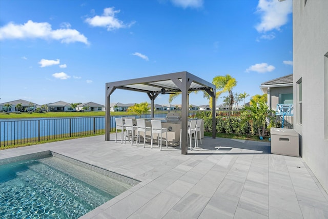 view of swimming pool featuring a patio area, an outdoor bar, and a water view