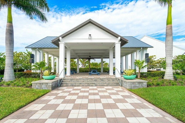 view of home's community with a patio area and a lawn