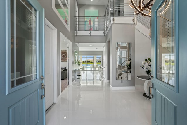 foyer entrance featuring a towering ceiling