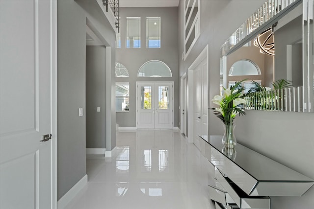 interior space featuring light tile patterned floors and a high ceiling