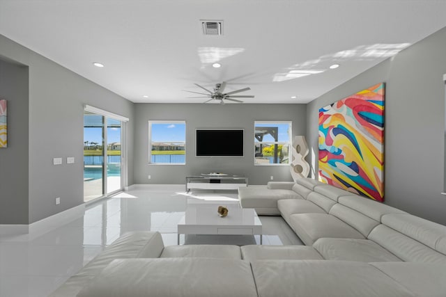 living room with ceiling fan and light tile patterned floors