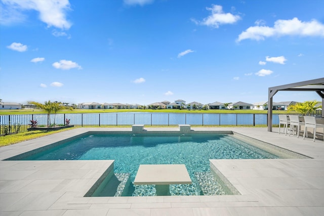 view of pool featuring a patio, a water view, and a bar