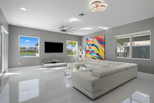 tiled living room with ceiling fan