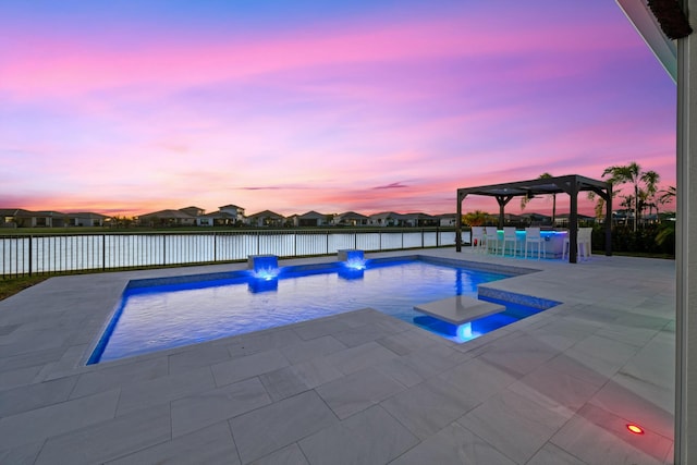 pool at dusk with a pergola and a patio area