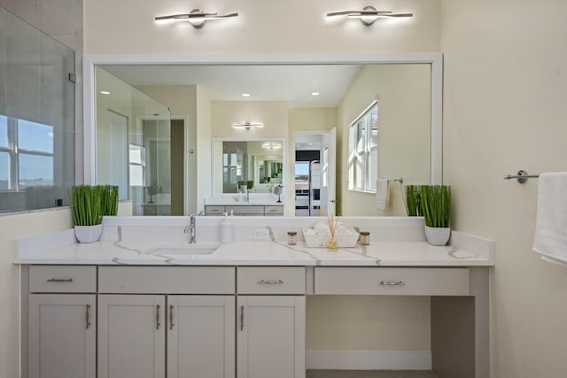 bathroom featuring vanity and an enclosed shower