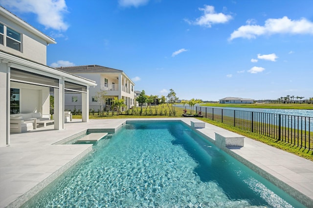 view of swimming pool with a water view and a patio area