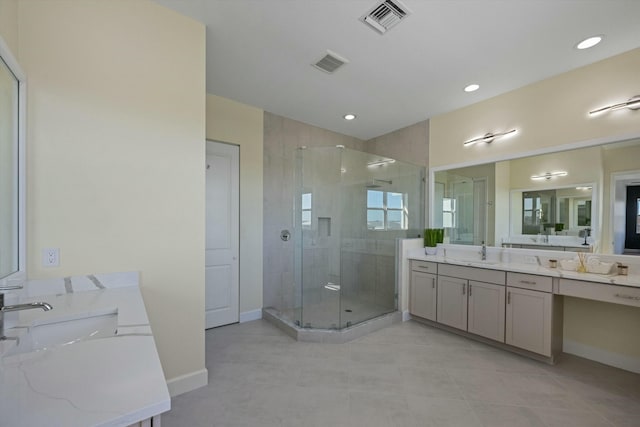 bathroom with vanity, tile patterned floors, and a shower with door