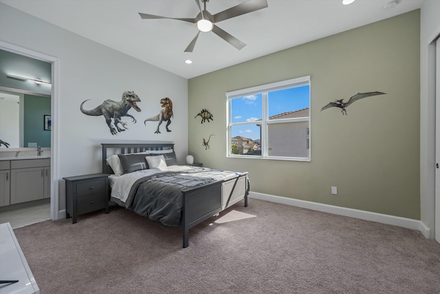 carpeted bedroom featuring ensuite bathroom and ceiling fan