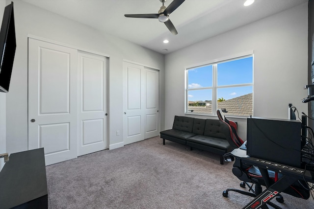 home office with light colored carpet and ceiling fan