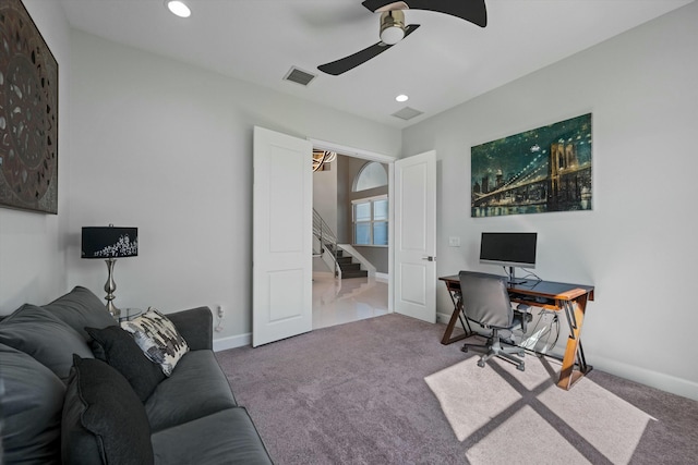 carpeted office space with ceiling fan