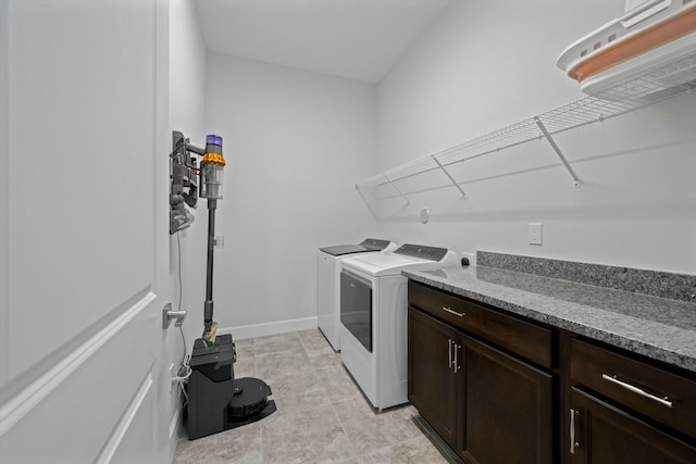 laundry room featuring cabinets and washing machine and clothes dryer