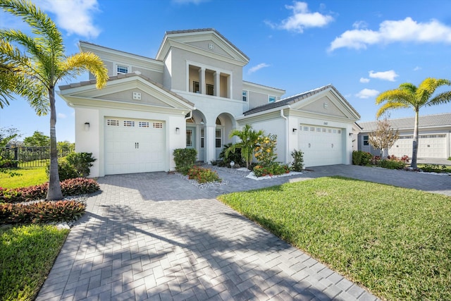 view of front of property featuring a garage and a front lawn