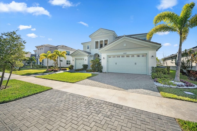 view of front of house with a garage and a front yard