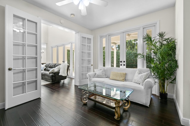 living room with dark hardwood / wood-style floors, ceiling fan, a wealth of natural light, and french doors