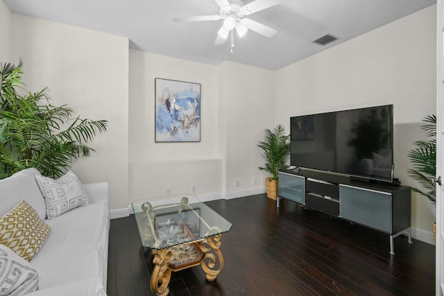 living room featuring dark hardwood / wood-style floors and ceiling fan