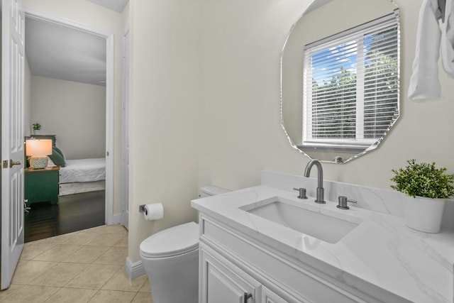 bathroom featuring tile patterned floors, vanity, and toilet