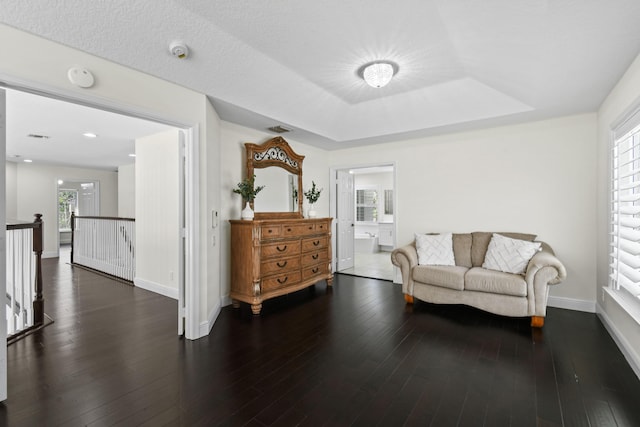 sitting room with dark hardwood / wood-style flooring and a healthy amount of sunlight