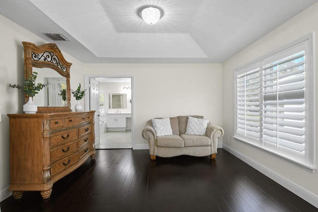 living area with dark hardwood / wood-style floors and a textured ceiling