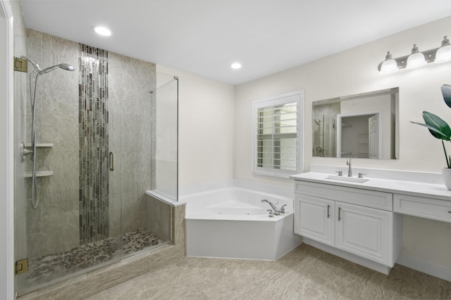 bathroom featuring vanity and independent shower and bath