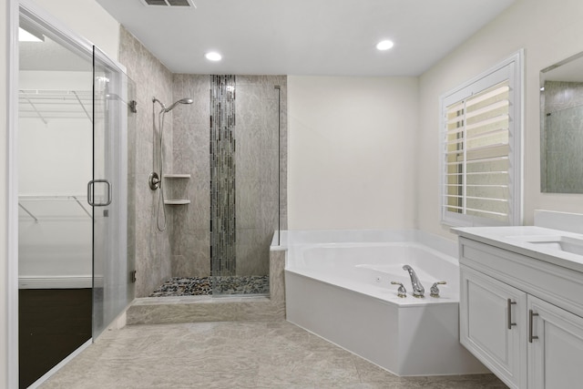 bathroom with tile patterned floors, vanity, and separate shower and tub