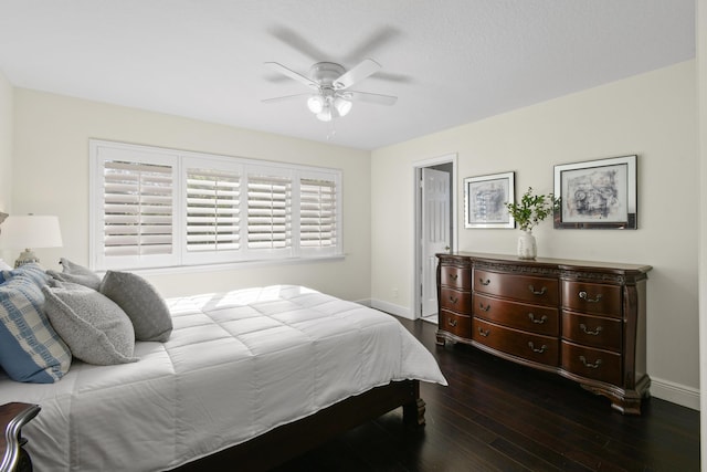 bedroom with ceiling fan and dark hardwood / wood-style flooring