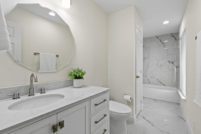 full bathroom with tiled shower / bath, vanity, and toilet