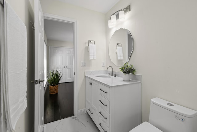 bathroom with vanity and toilet