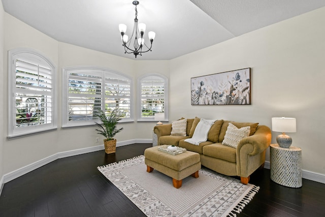 living room featuring dark hardwood / wood-style flooring and a notable chandelier