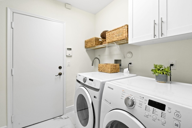 washroom featuring cabinets and independent washer and dryer